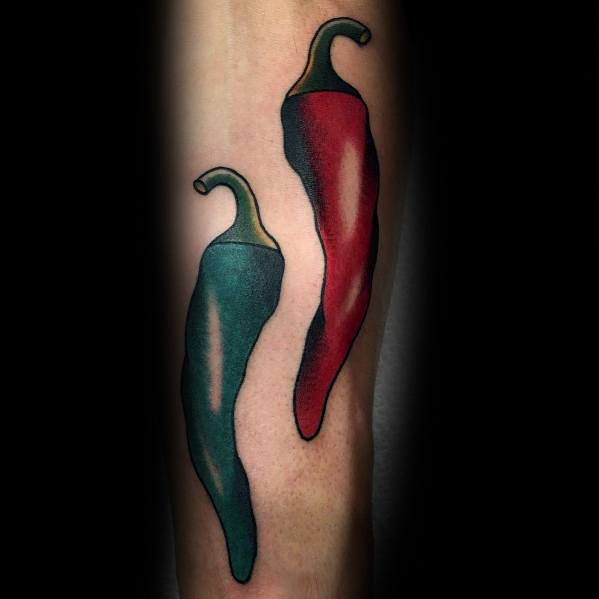 Tattoo of two chili peppers, one red and one green, with bold shading and smooth gradients for a striking and balanced design.