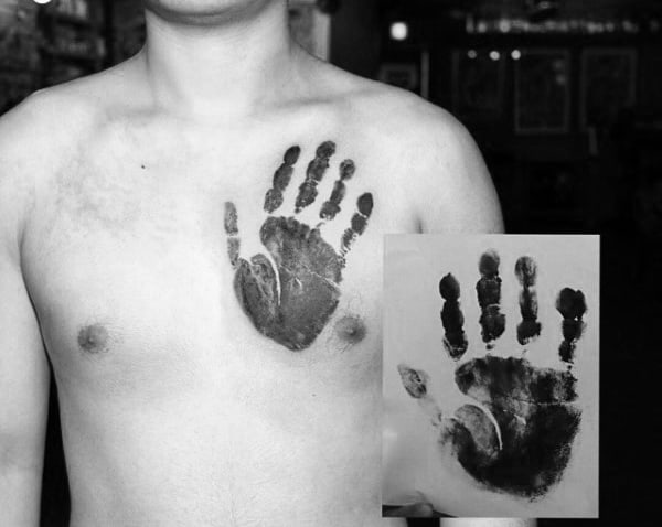Man With Realistic Handprint Black Ink Tattoo On Upper Chest