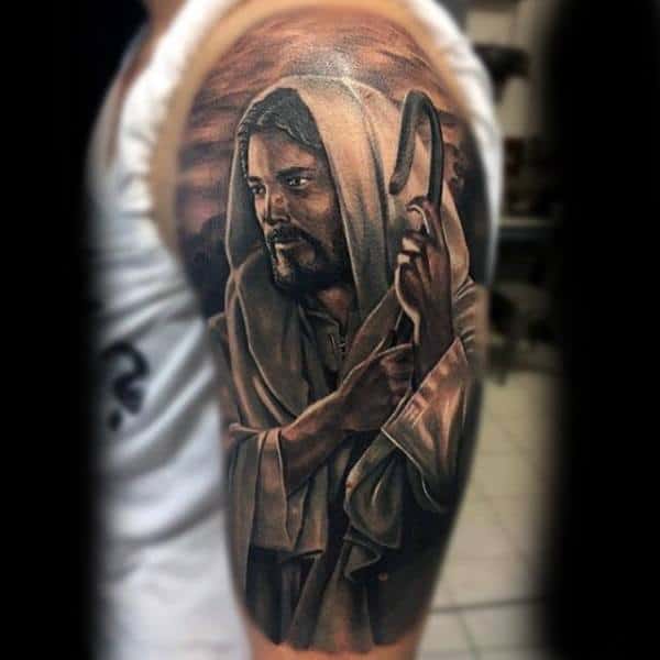 Man With Religious Veiled Lord Tattoo On Sleeves