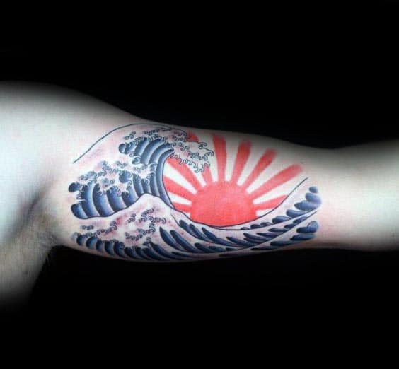 man-with-rising-sun-waves-bicep-tattoo