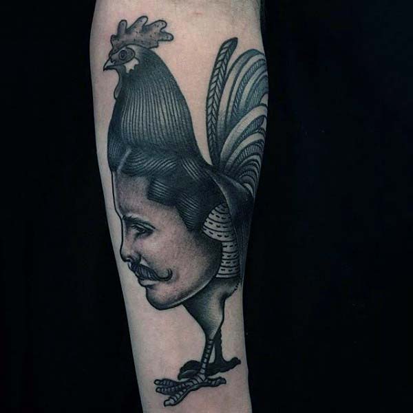 Man With Rooster And Face Tattoo On Forearm In Blackwork