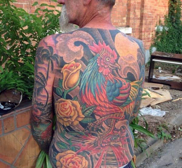 Man With Rooster And Flower Tattoo On Back In Traditional Style