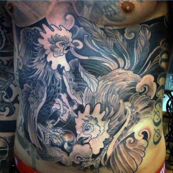 Man With Rooster Tattoo On Abs With Wavelike Feathers