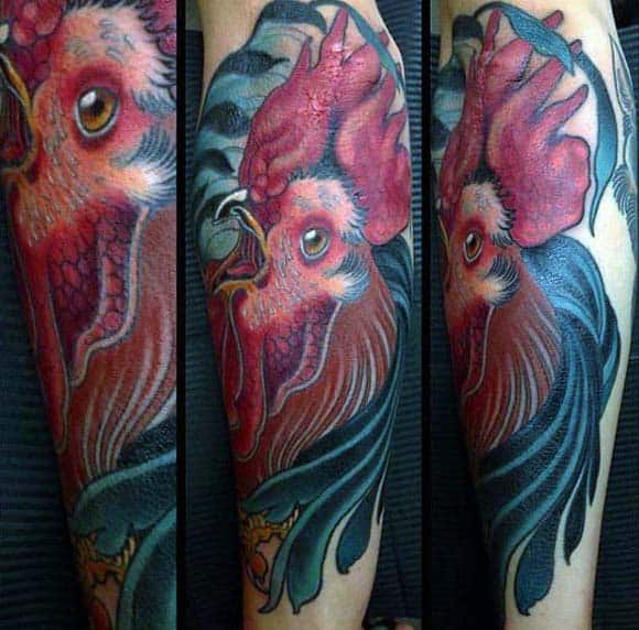 Man With Rooster Tattoo On Forearm Blue Nd Red Ink