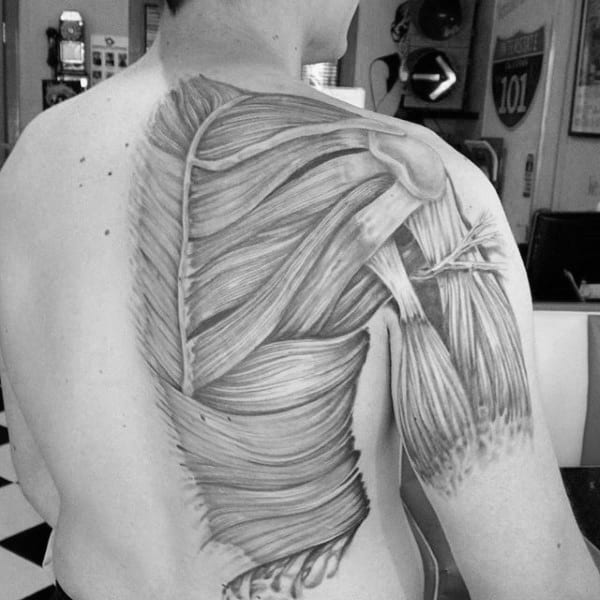Man With Shaded Black And Grey Muscle Back Tattoo