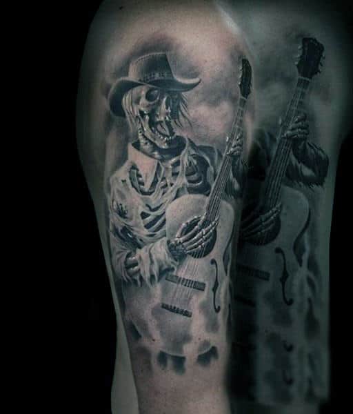 Man With Skeleton Playing Guitar Tattoo On Shoulders