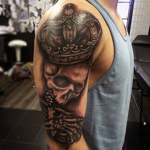 Man With Skull And Noble Crown Tattoo Biceps