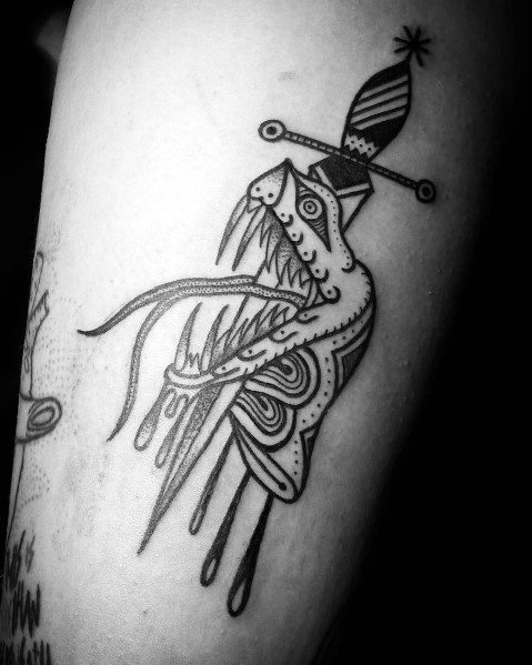 Tattoo of a stylized snake with sharp teeth and a sword through its head, featuring intricate patterns and dripping effects.