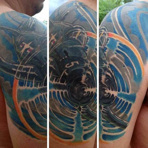 Colorful tattoo of an airplane engine in motion on a person's shoulder and upper arm
