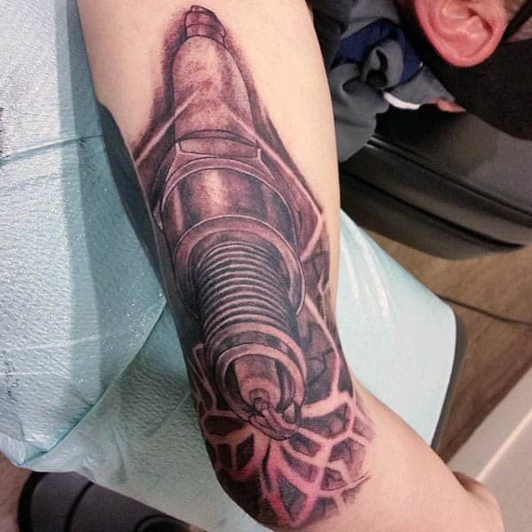 Man With Spark Plug Tattoo On Inner Arm