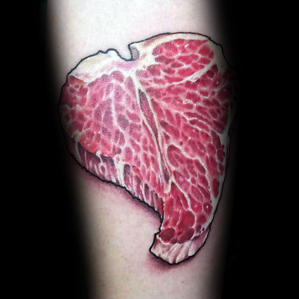 Tattoo of a highly detailed raw steak with realistic marbling and bold shading, shaped like a heart for a striking and unique meat-inspired design