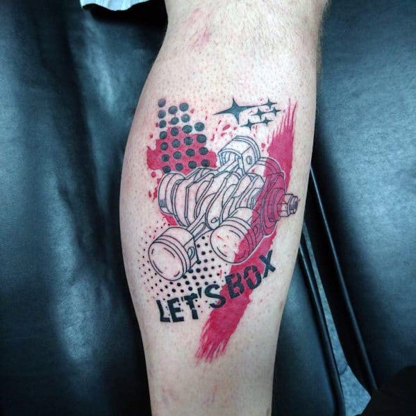 Subaru boxer engine tattoo with a bold red and black design, featuring the "LET'S BOX" text, Subaru stars, and artistic splatter effects.