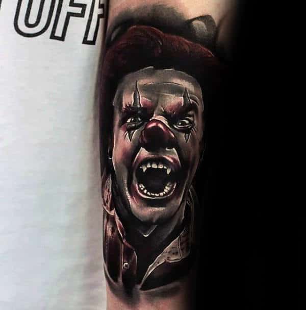 Man With Tattoo Of Angry Clown On Arms