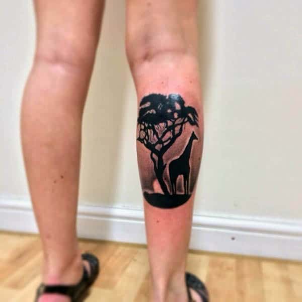 Man With Tattoo Of Giraffe Silhouette On Leg Calf