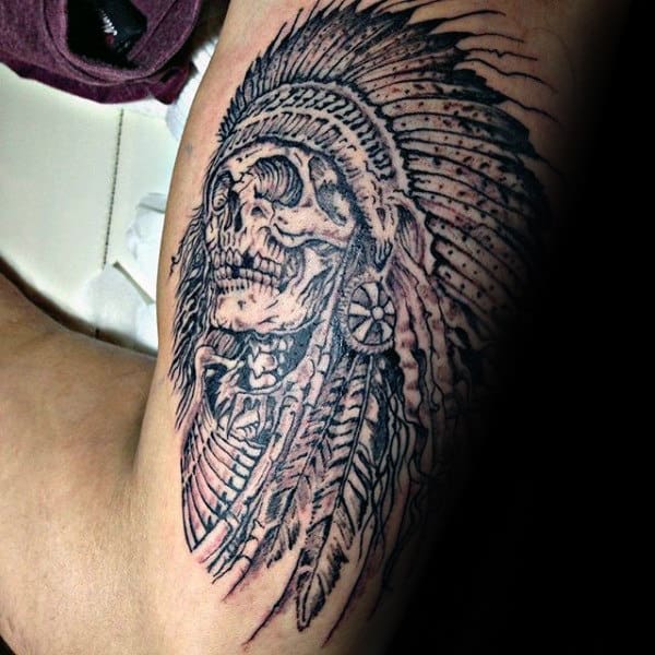 Man With Tattoo Of Indian Skull On Outer Arm Bicep