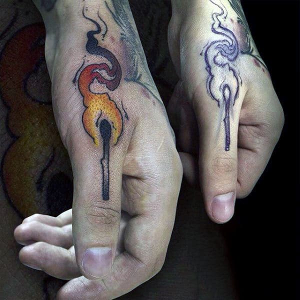 Two thumbs with matching tattoos of a matchstick: one burning, one extinguished