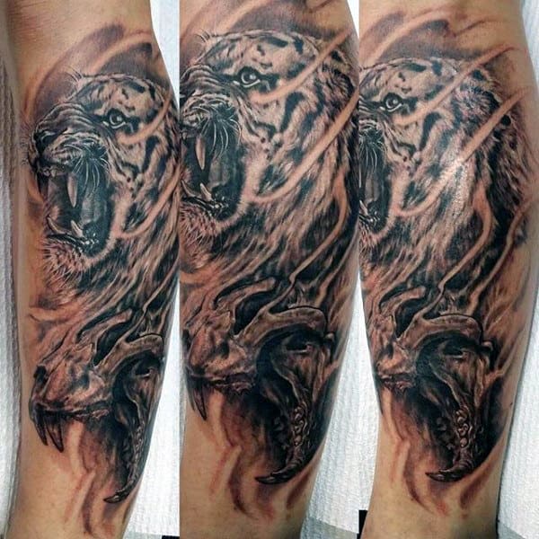 Tattoo of a roaring tiger and skull on a forearm =