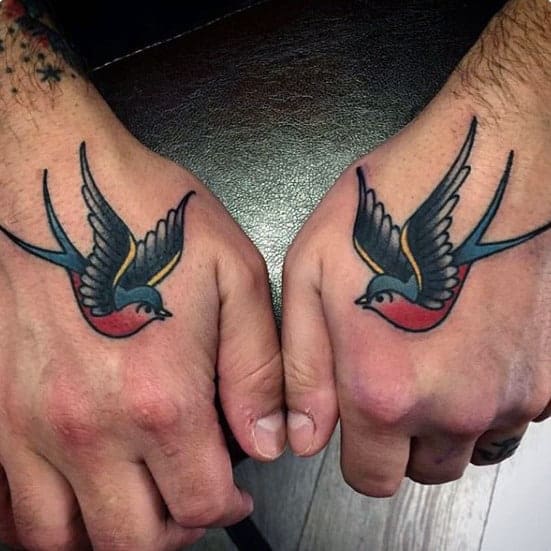 man-with-traditional-swallow-tattoos-on-hands