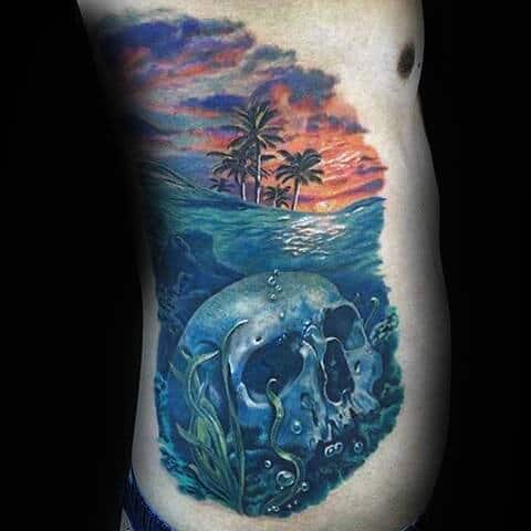 Man With Underwater Skull And Sunset Side Tattoo In Realistic Style