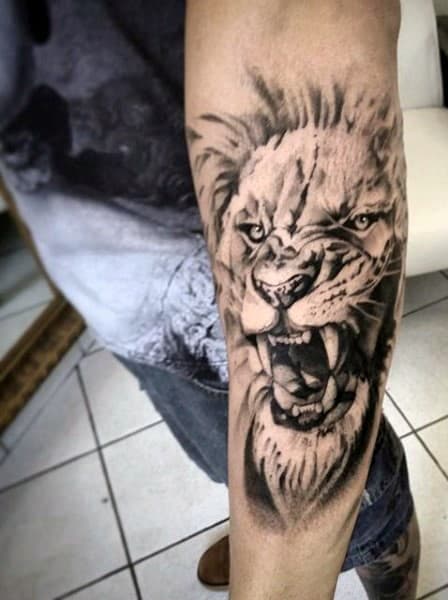Man With White And Grey Ink Outer Forearm Lion Tattoo Design