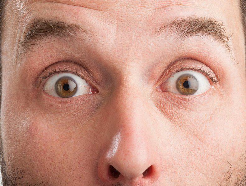 man with wide eyes open