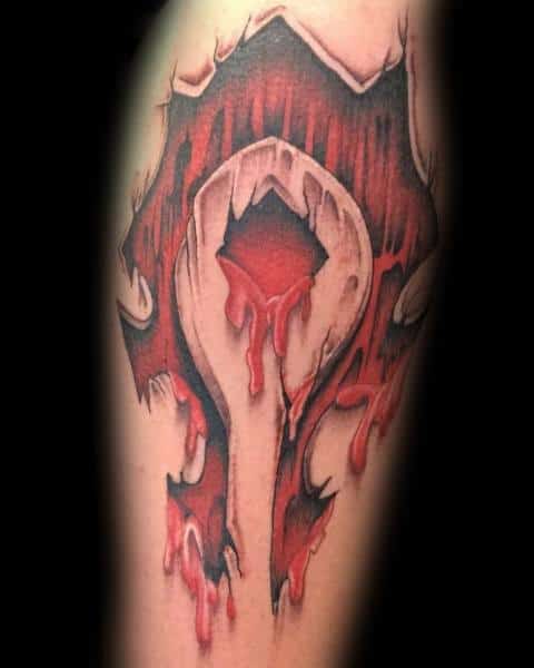 Tattoo of the Horde emblem from World of Warcraft, designed with a ripped skin effect and dripping red ink for a bold and intense look, inked on the forearm.