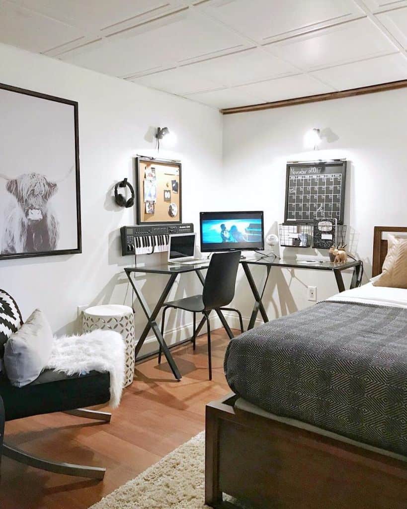 Man cave bedroom with a music studio setup, modern desk, and cozy seating area.