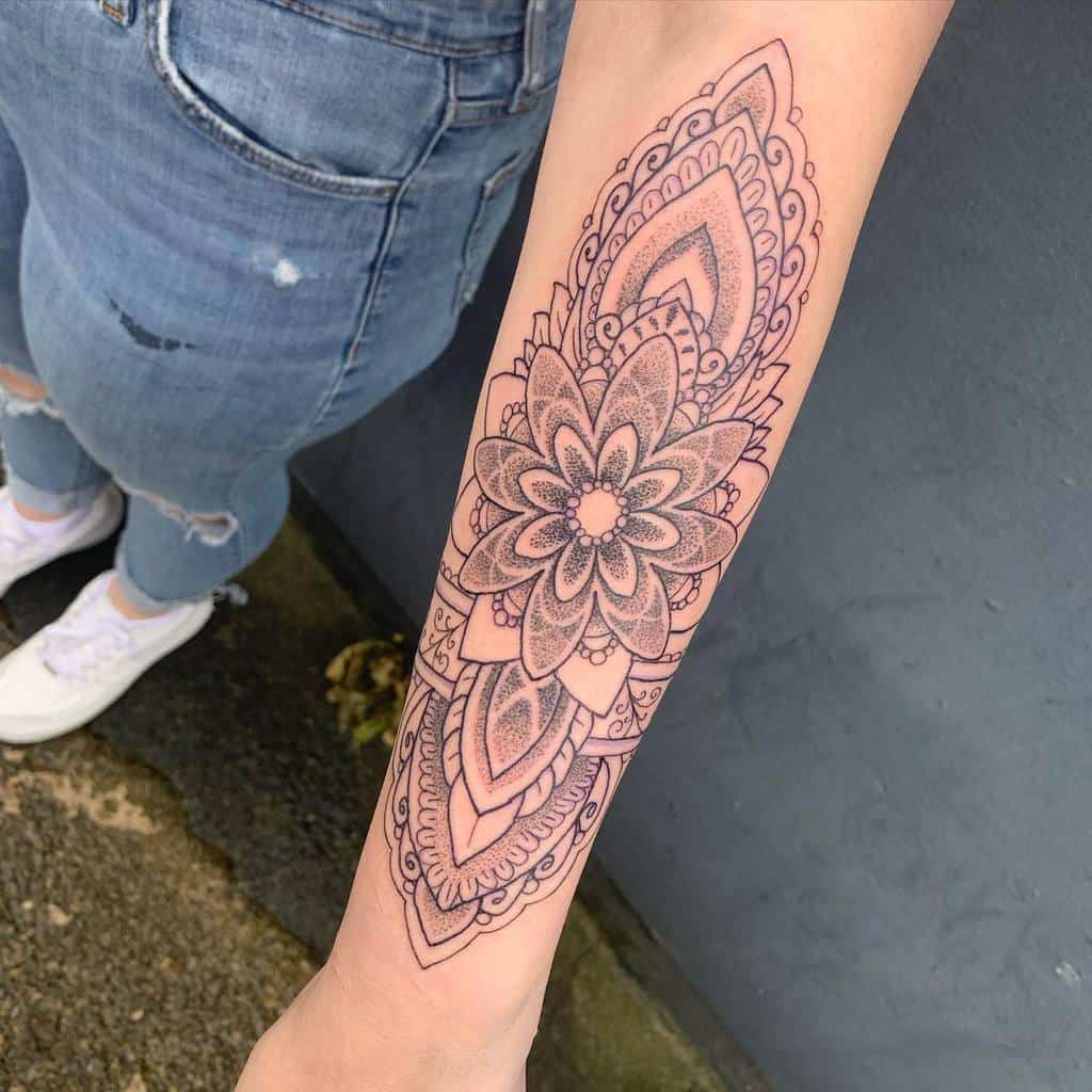 Forearm tattoo with intricate mandala design