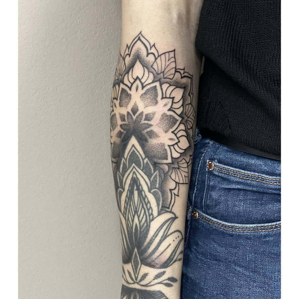 Tattooed forearm with a geometric plant design