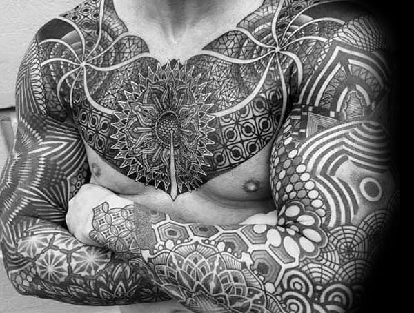 Blackwork geometric tattoo covering the chest, arms, and hands, featuring intricate symmetrical patterns, mandalas, and tribal-inspired designs.