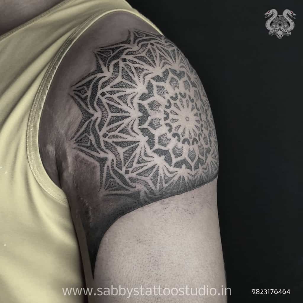 Ornate mandala tattoo on a shoulder