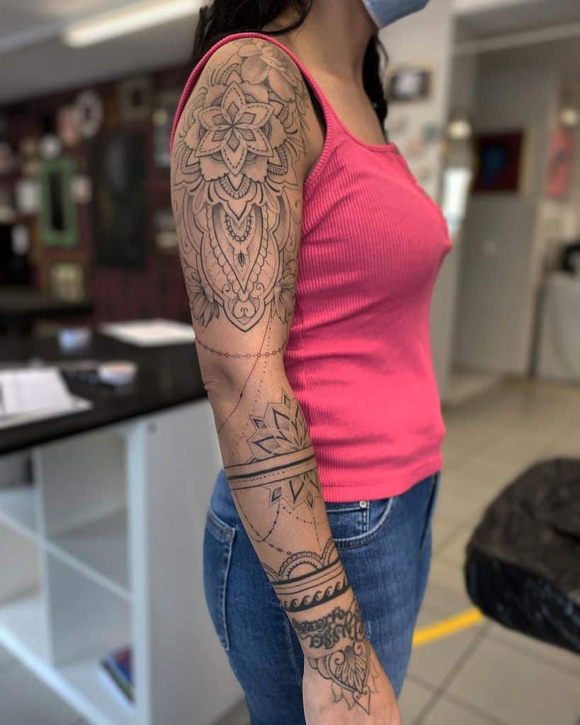 Woman with a mandala sleeve tattoo on her upper arm