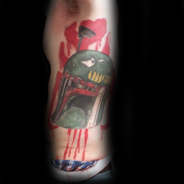 Boba Fett helmet tattoo in full color with dripping red paint effect, creating a dramatic and bold look on the upper arm.