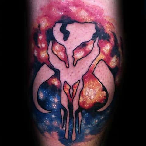 Mandalorian Mythosaur skull tattoo outlined over a vivid cosmic galaxy background with fiery red, orange, and deep blue tones.