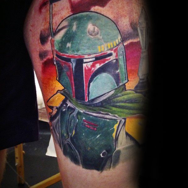 Colorful Boba Fett tattoo featuring detailed armor and green cape, set against a fiery sunset background on the upper arm.