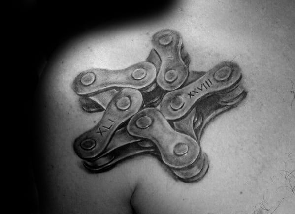 3D star-shaped tattoo made of interlocking bike chain links with engraved Roman numerals, creating a mechanical look on the shoulder.