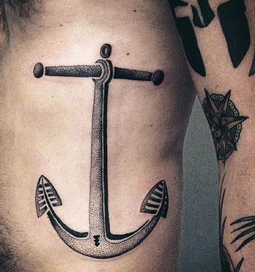A detailed anchor tattoo on the side of a torso