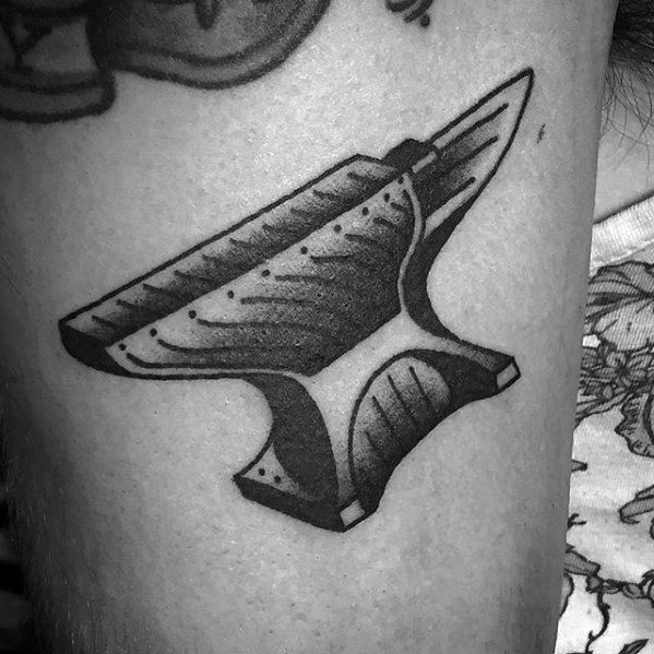 Black and grey anvil tattoo with bold outlines and detailed shading, giving it a classic, traditional feel with a modern twist.