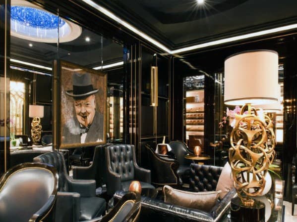 Luxurious cigar lounge with leather chairs, ornate decor, and a portrait on the wall
