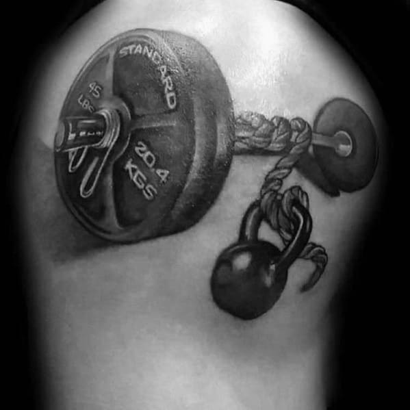 Realistic shoulder tattoo of a barbell tied with a thick rope and kettlebell, symbolizing raw strength, struggle, and unbreakable determination.