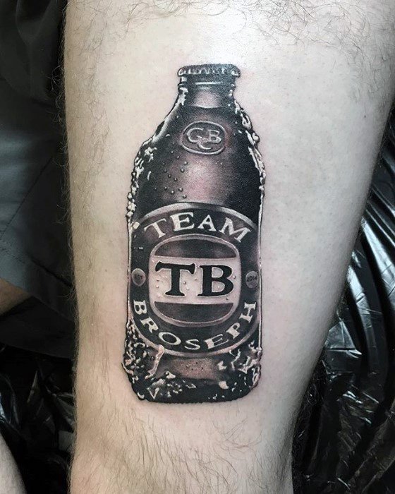 Realistic black and gray tattoo of a beer bottle labeled "Team Broseph" with "TB" in the center, detailed with condensation and branding effects.