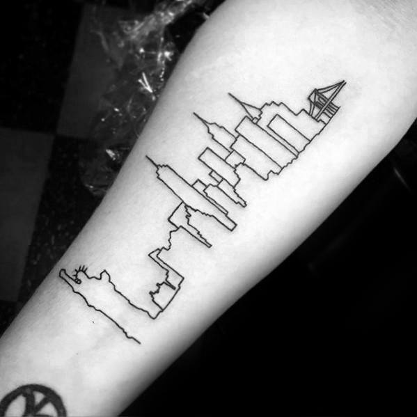 Minimalist black line tattoo of the New York City skyline, including the Statue of Liberty and Brooklyn Bridge on the forearm.