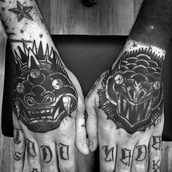Blast over black and white tattoos of mythical creatures on hands, with stars and letters