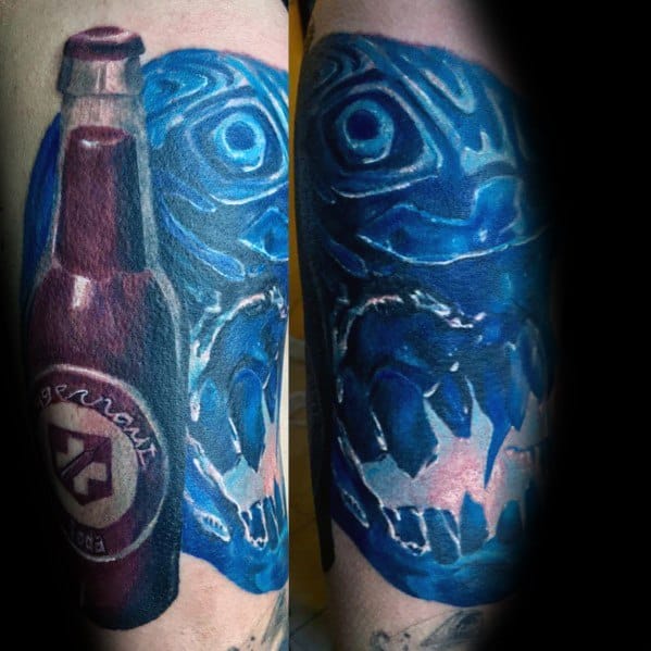 Vivid Call of Duty Jugger-Nog tattoo featuring a glowing blue zombie skull, intense shading, and a realistic soda bottle for a striking design.