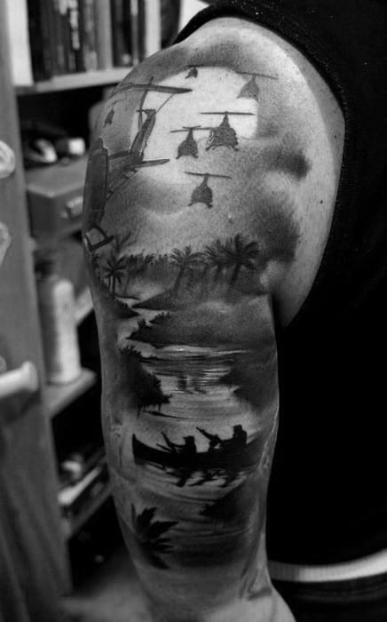 Alt text: Detailed black and grey tattoo of a serene river scene with canoes, palm trees, and helicopters overhead, creating a contrast of peace and action.