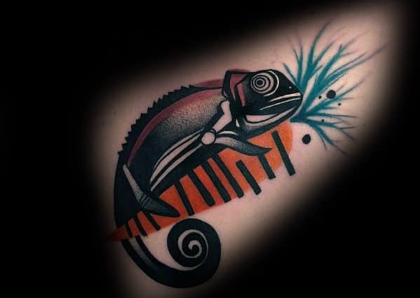 Stylized chameleon tattoo with bold black, orange, and blue tones, blending geometric patterns and abstract elements for a striking design.