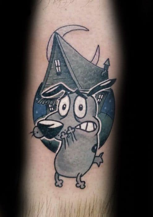 Tattoo of Courage the Cowardly Dog with a scared expression, set in front of his crooked house under a crescent moon and starry night sky.
