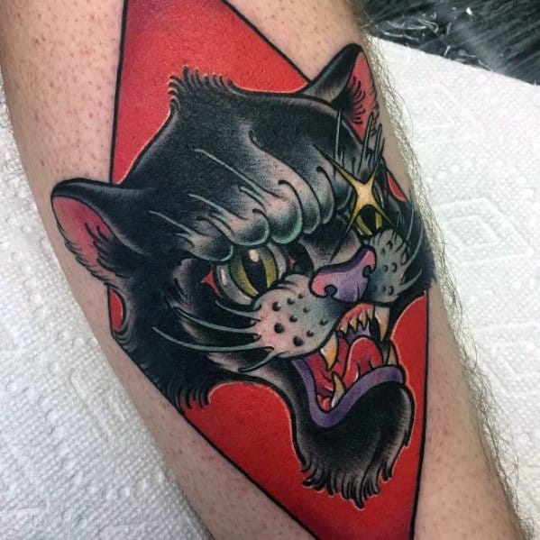 Bold neo-traditional tattoo of a fierce black cat with vibrant colors, sharp details, and a red background for a striking design.