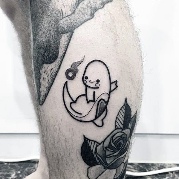 Minimalist black ink Charmander tattoo with a cute, abstract design and floating flame, placed on the lower leg near a rose tattoo.