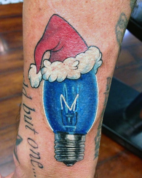 Christmas tattoo of a blue holiday light bulb wearing a Santa hat, blending festive cheer with a creative and vibrant design.